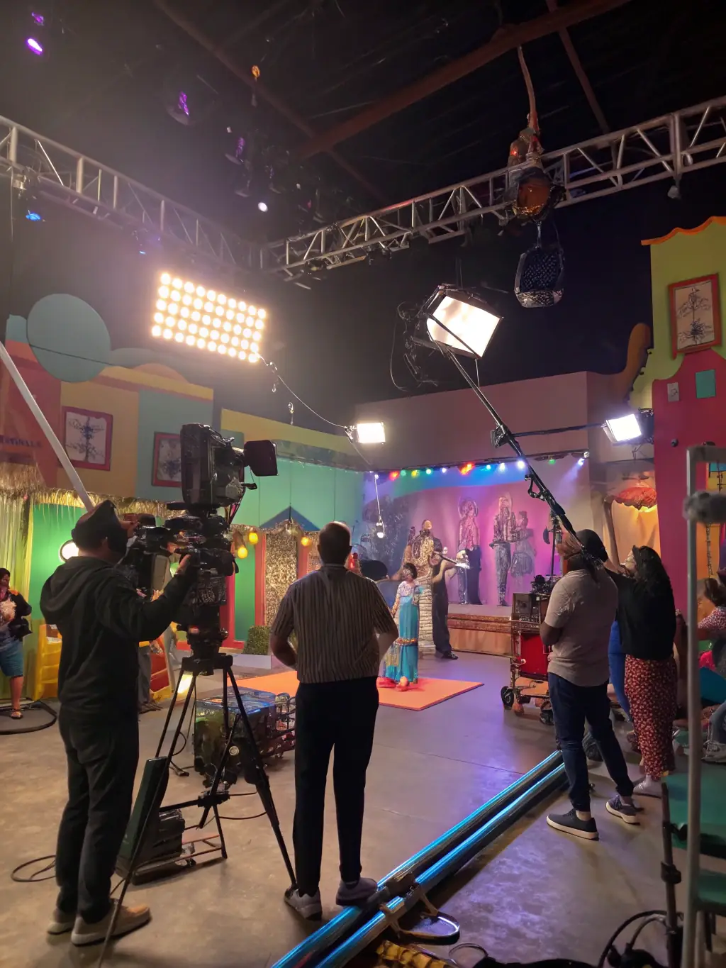 A behind-the-scenes shot of a video production, with crew members filming a scene, emphasizing the studio's involvement in video production and support for filmmakers.
